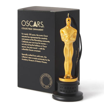 Gold Oscar statuette collectible ornament with black box on a white background